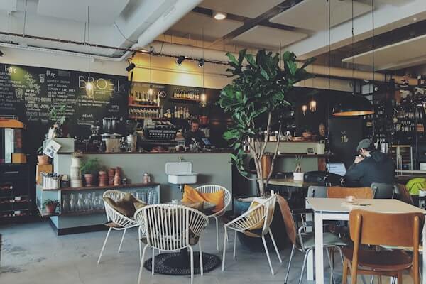Modern café with light kitchen and compact ESP exhaust system