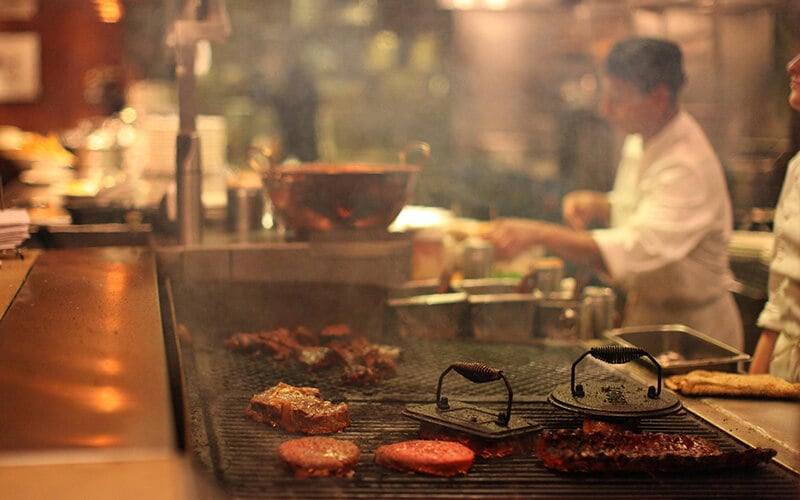 Western steakhouse charbroiler grill producing smoke for ESP filtration